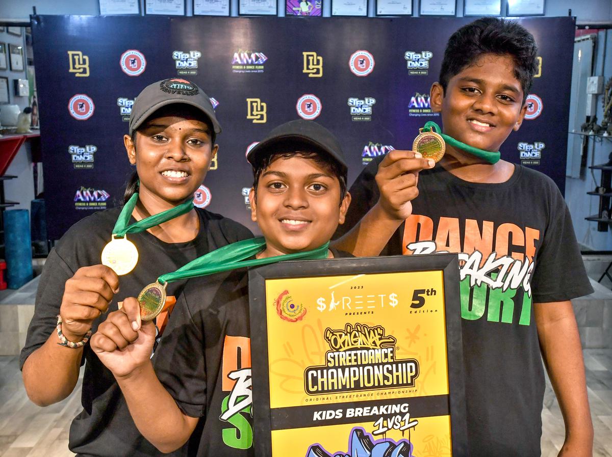 Break dancers with their medals won in various competitions.