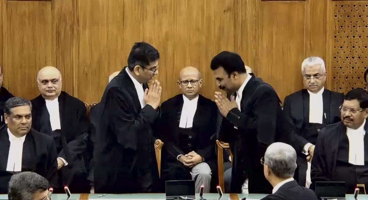 Chief Justice of India (CJI) Justice DY Chandrachud greets Justice R Mahadevan after administering oath of office to the latter as Judge of Supreme Court of India during the swearing-in ceremony, in New Delhi, Thursday, July 18, 2024.