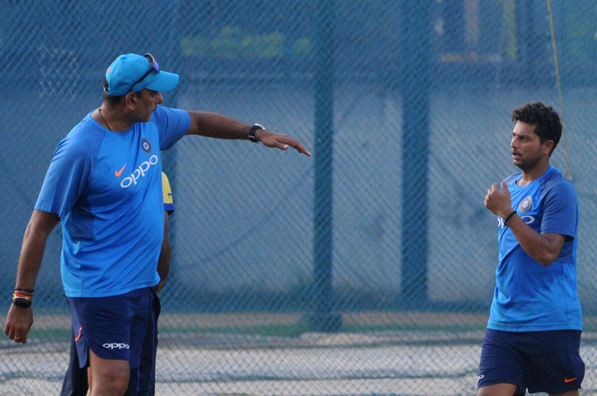 Indian cricket coach Ravi Shastri (left) with Kuldeep Yadav during a practice session at the M.A. Chidambaram Stadium, Chepauk in Chennai in September, 2017. 