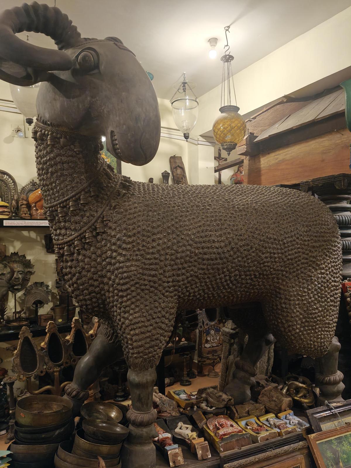 The sculpture of a wooden ram at an antique store on Synagogue Lane
