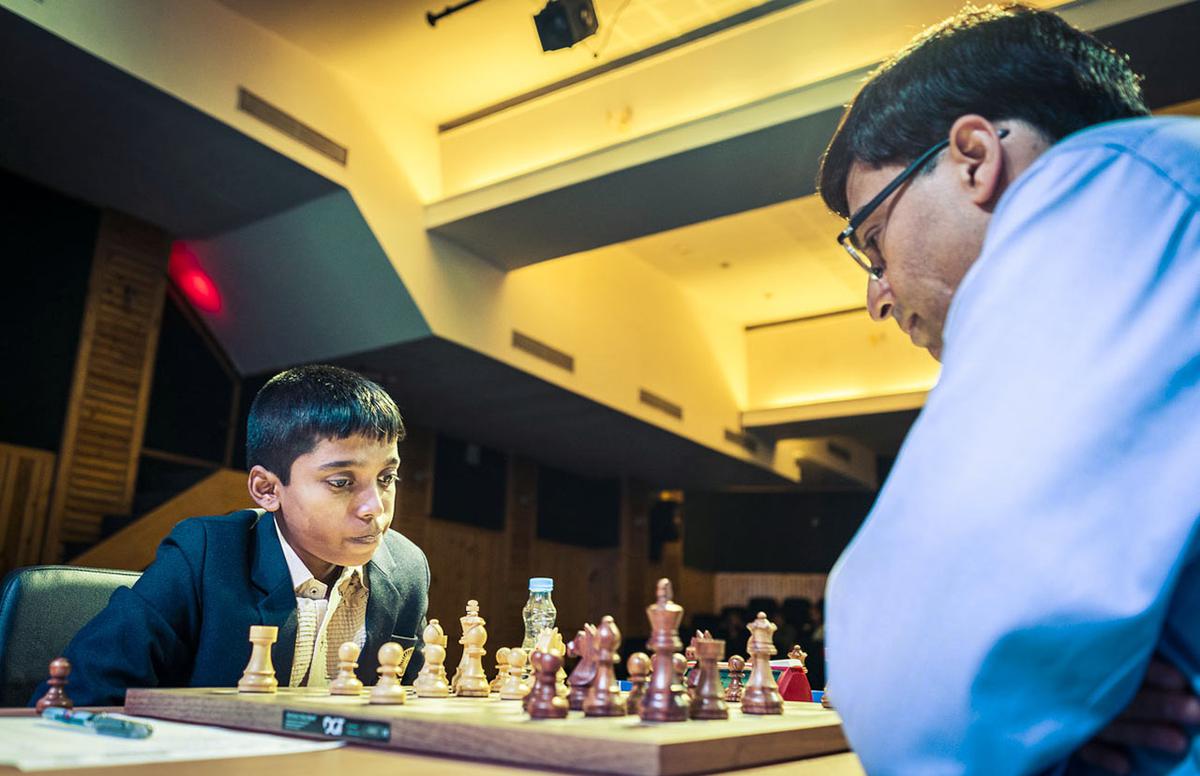 Vishwanathan Anand, right, and R. Praggnanandhaa. 