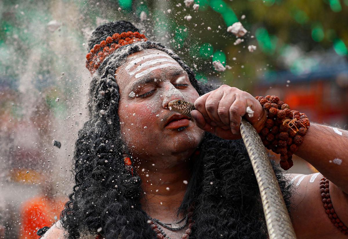 A devotee dressed as Lord Shiva performs with a snake during a religious procession ahead of ‘Maha Shivratri’ festival, in Jammu, Friday, Feb 17, 2023. 