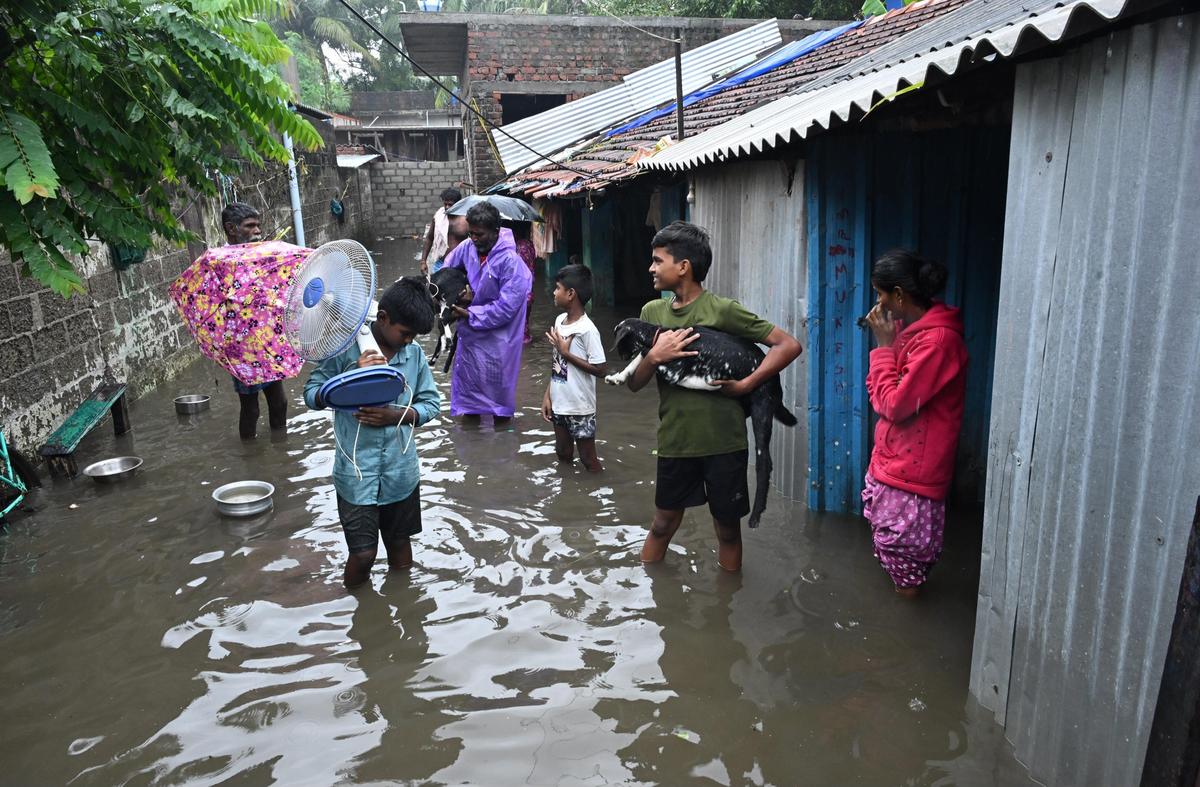 Residents walking in waterlogged street at   Gandhi Nagar in Rameswaram on Saturday. 