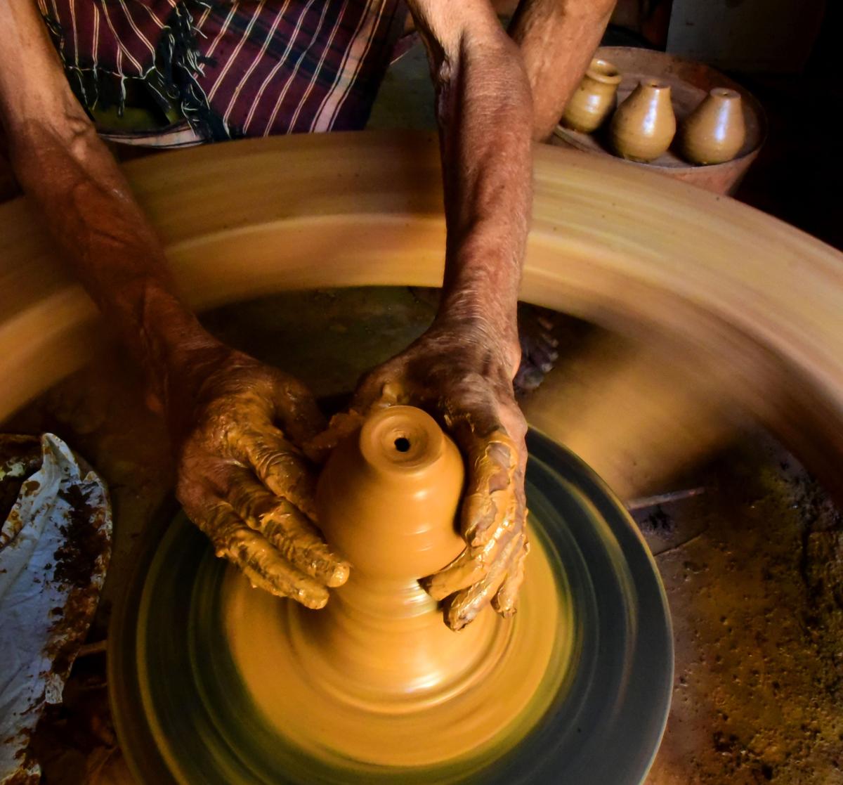 A traditional potter making deepams on the potter’s wheel ahead of Deepavali at Kummari Veedhi in Visakhapatnam. 