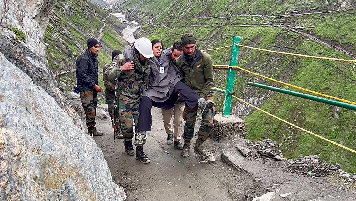 Indian Army personnel rescue an injured pilgrim from the cloudburst affected areas near the Amarnath cave shrine, Jammu & Kashmir, on July 9, 2022. At least 15 persons were killed and 25 injured in the flash flood.
