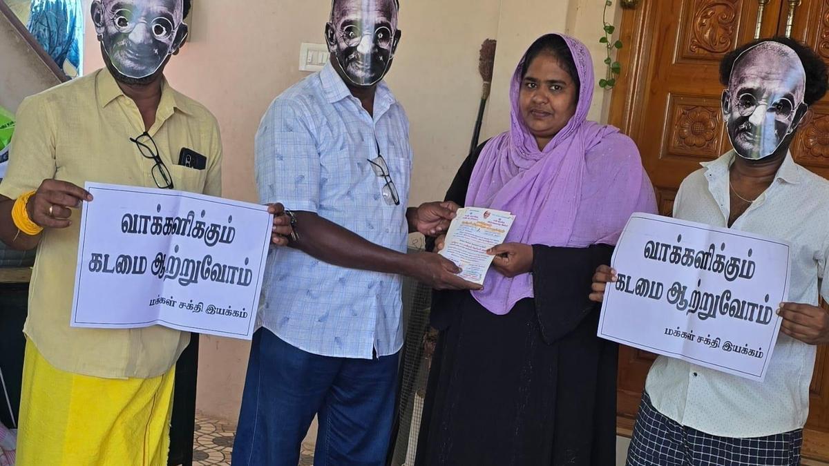 Volunteers don Gandhi masks for election awareness campaign