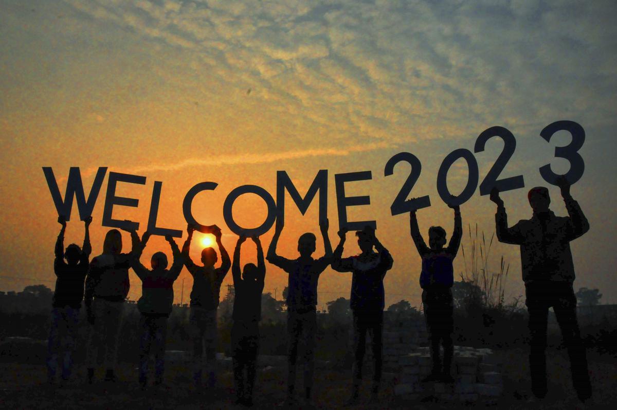 People welcoming 2023 pose for a picture with the last setting sun of 2022, in Moradabad on Saturday, Dec. 31, 2022. 