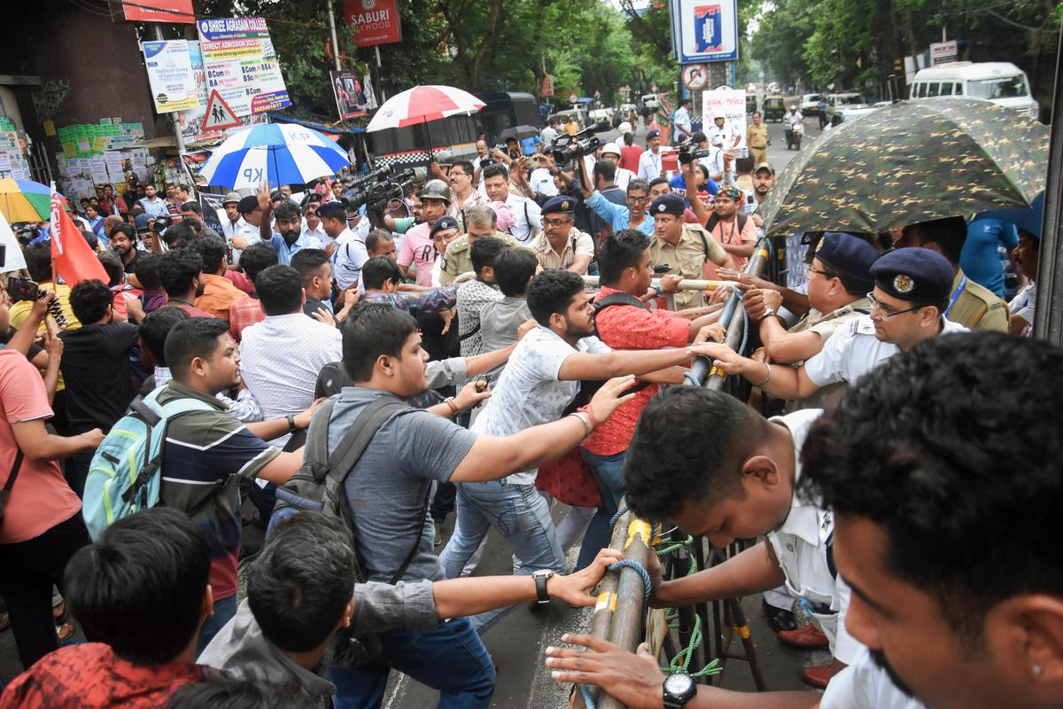 Students’ Federation of India (SFI) and other left student organisation supporters in a scuffle with police personnel during the protest against the death of Jadavpur University first-year student Swapnadeep Kundu, in Kolkata on Thursday. 