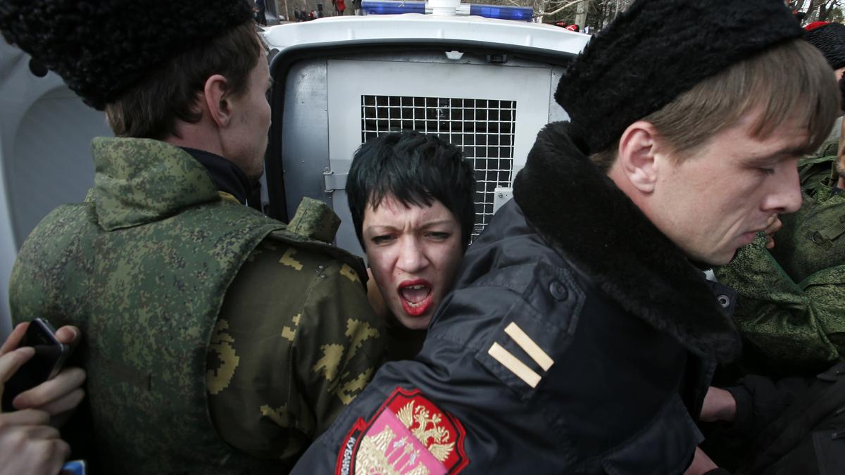 Topless anti-Russia protesters damage monument outside UN in Geneva