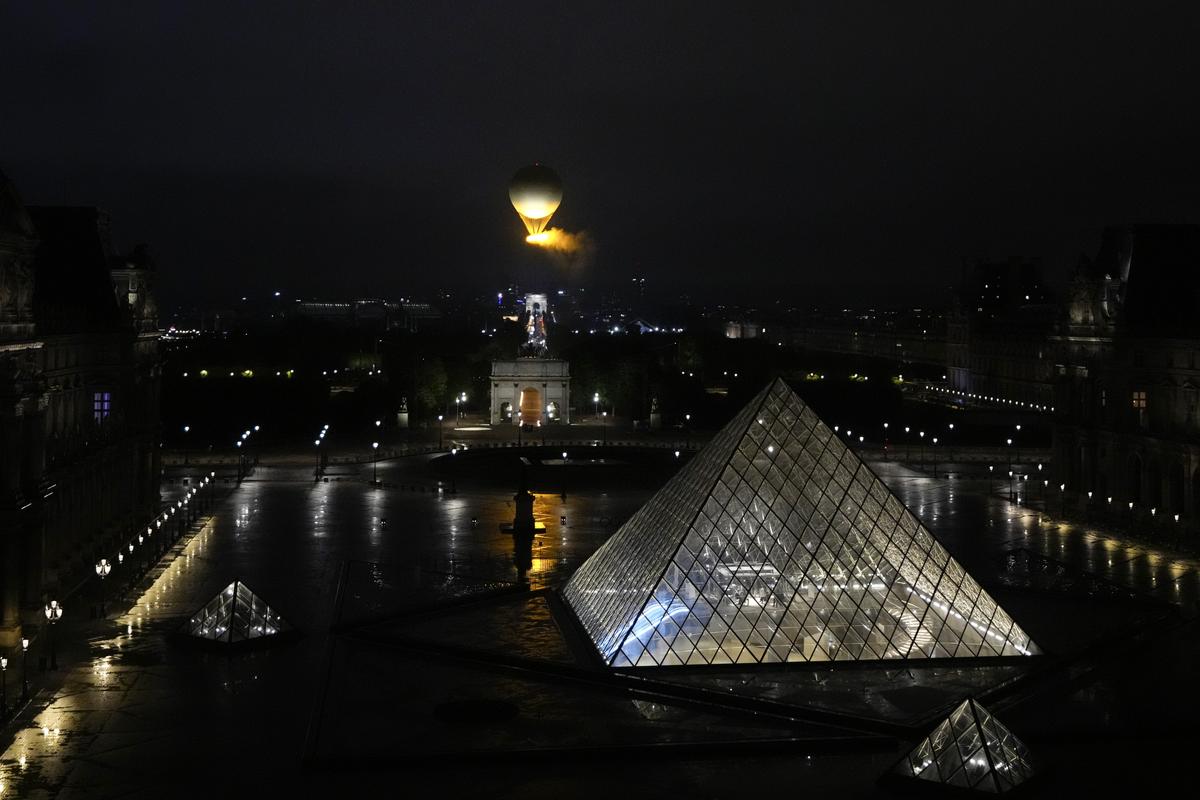  The cauldron, with the Olympic flame lit, lifts off while attached to a balloon during the Opening Ceremony of the Olympic Games Paris 2024 on July 26, 2024 in Paris, France. 