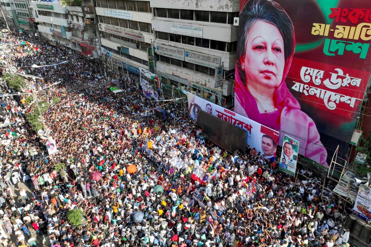 In this aerial photograph, Bangladesh Nationalist Party (BNP) activists gather near a poster of BNP chairperson Khaleda Zia, during a rally in Dhaka on August 7, 2024. 