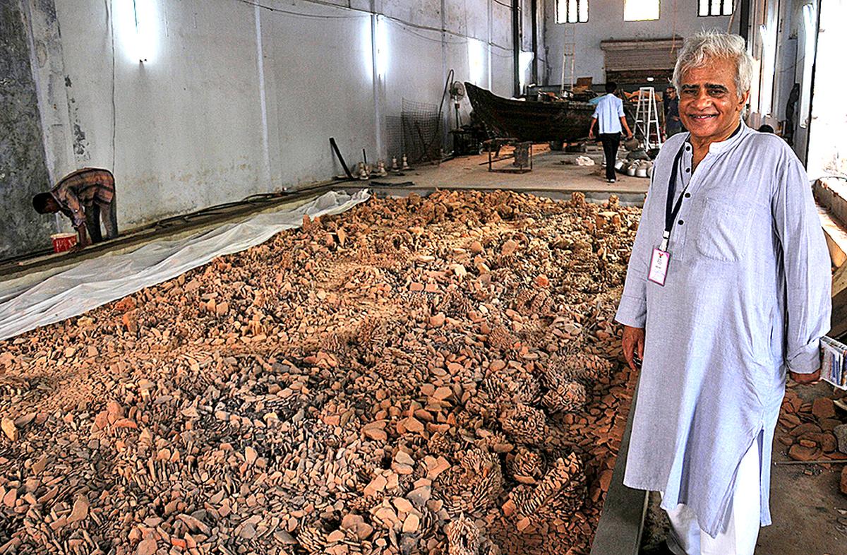 Vivan Sundaram with discarded terracotta shards from the Muziris excavation site at Pattanam for the Kochi-Muziris.