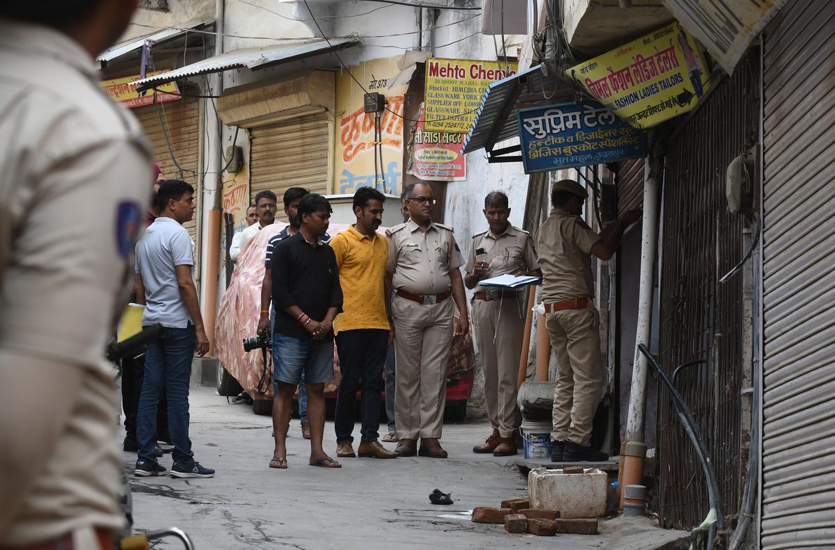 A National Investigation Agency team alone with the local police team visits the shop of tailor Kanhaiya Lal Teli.