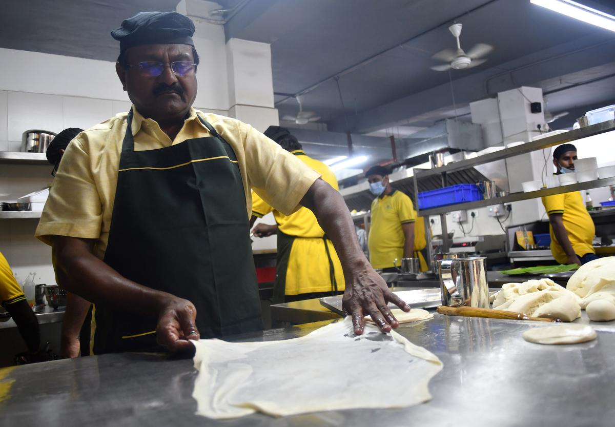 K. Murthy proprietor of Junior Kuppanna making parotta attheir newly launched 24-hour drive-in restaurant at thUrban Square in Kathipara.