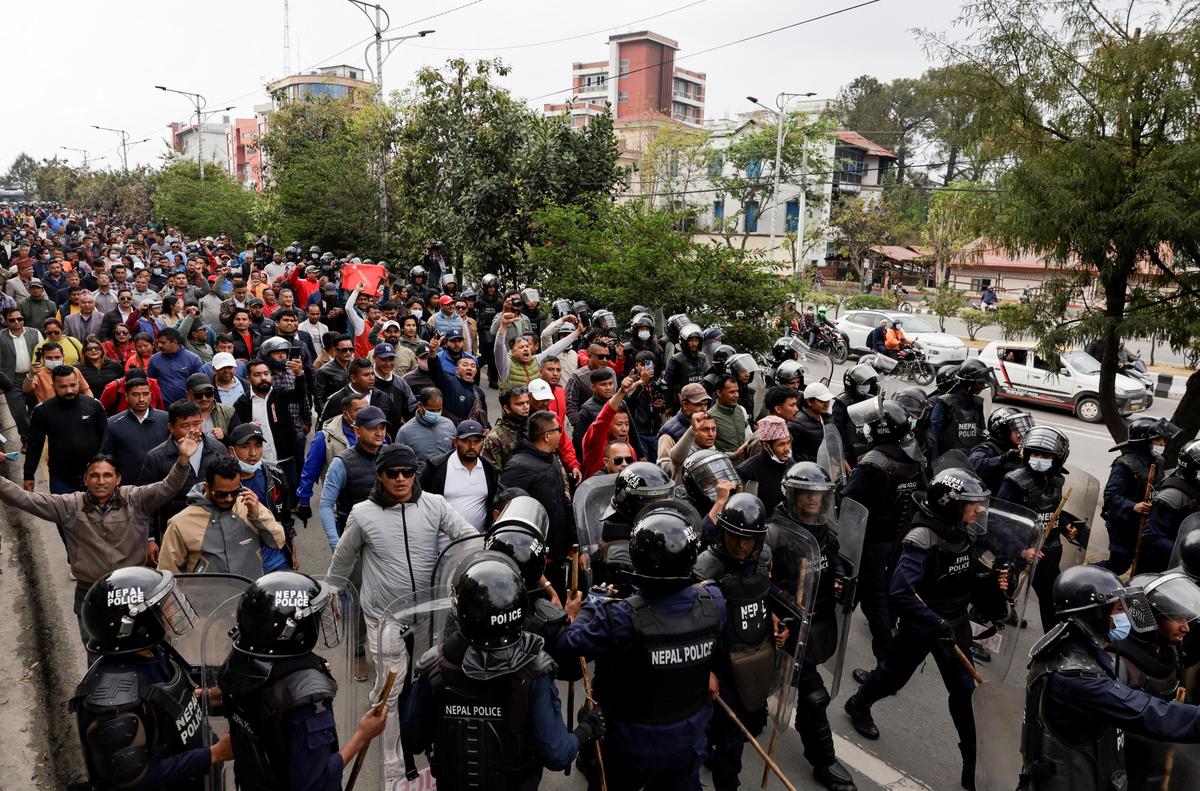 Supporters of Nepal's former Prime Minister and Chairman of the Communist Party of Nepal (Unified Marxist–Leninist) K.P. Sharma Oli march escorted by police during a protest following Oli's detention by police, who are investigating whether he was negligent in preventing dozens of deaths during the Gen Z protests, in Kathmandu, Nepal, March 29, 2026.