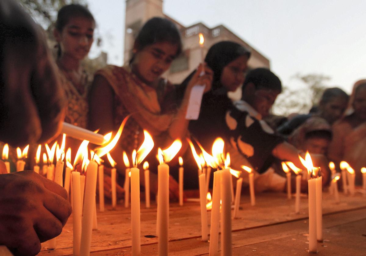 Muslim women light candles on the anniversary of the Godhra riots. 