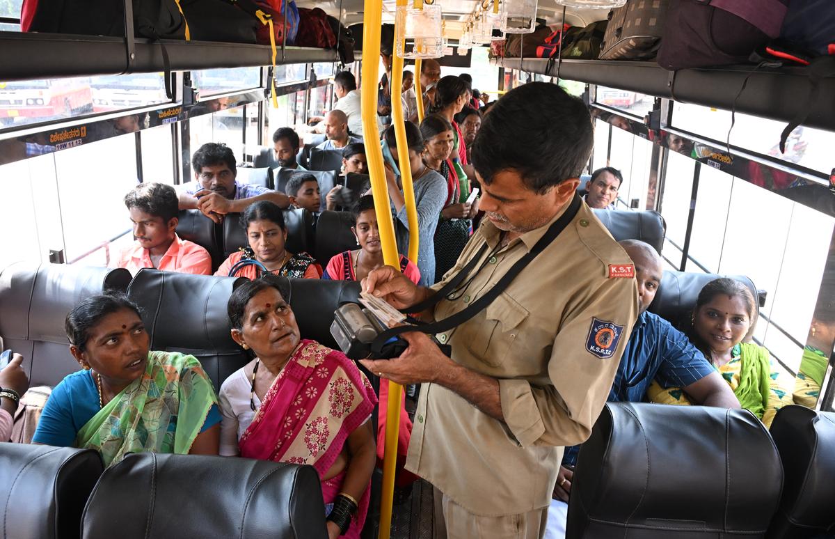 A KSRTC conductor verifying ID cards of women passengers in a bus at the temple town of Dharmasthala in Dakshina Kannada district. 