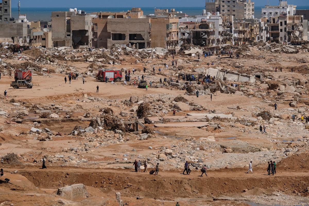 A view shows people inspecting the damaged areas, in the aftermath of the floods in Derna, Libya September 14, 2023. 