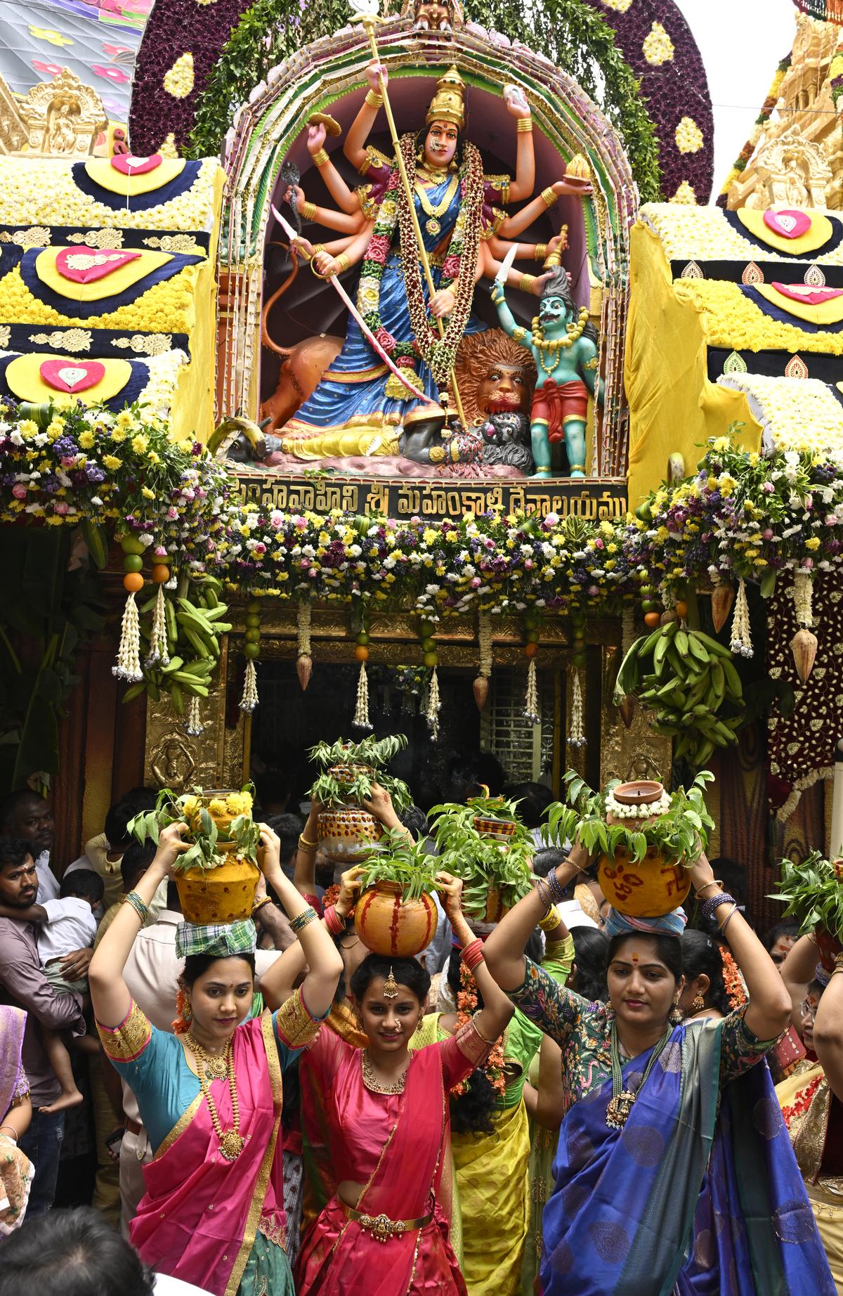 Devotees carry bonams during Bonalu festival at Lal Darwaza Simhavahini Mahankali Temple in Hyderabad on Sunday. Devotees carry bonams during Bonalu festival at Lal Darwaza Simhavahini Mahankali Temple in Hyderabad on Sunday.