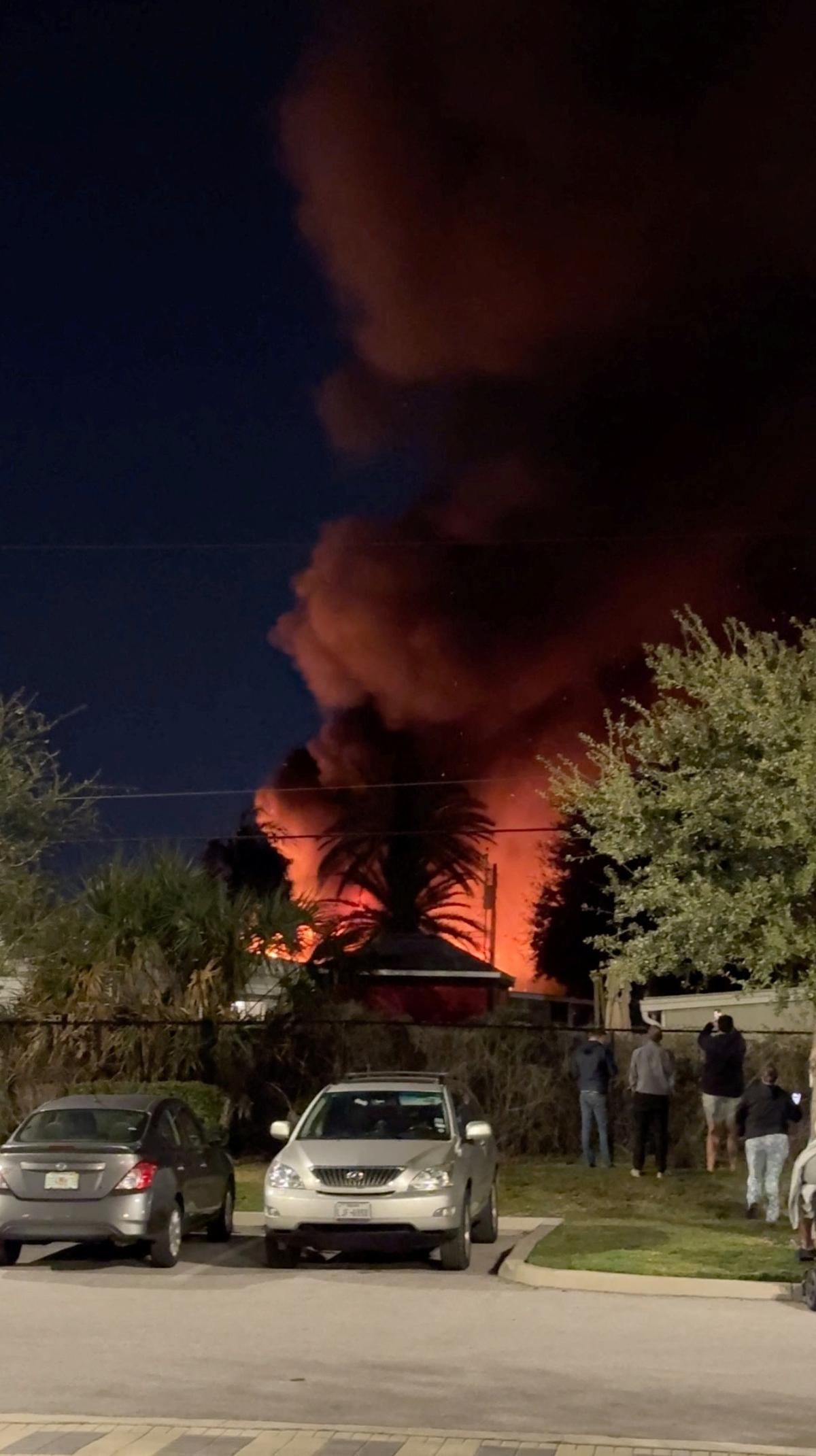 A plume of smoke rises after a small plane crashes in a trailer park in Clearwater, Florida, U.S., February 1, 2024, in this screen grab obtained from a social media video. 