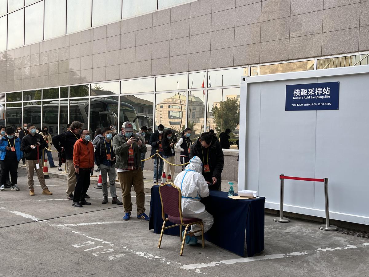 Journalists attending the party congress in Beijing queue up for COVID-19 testing. 