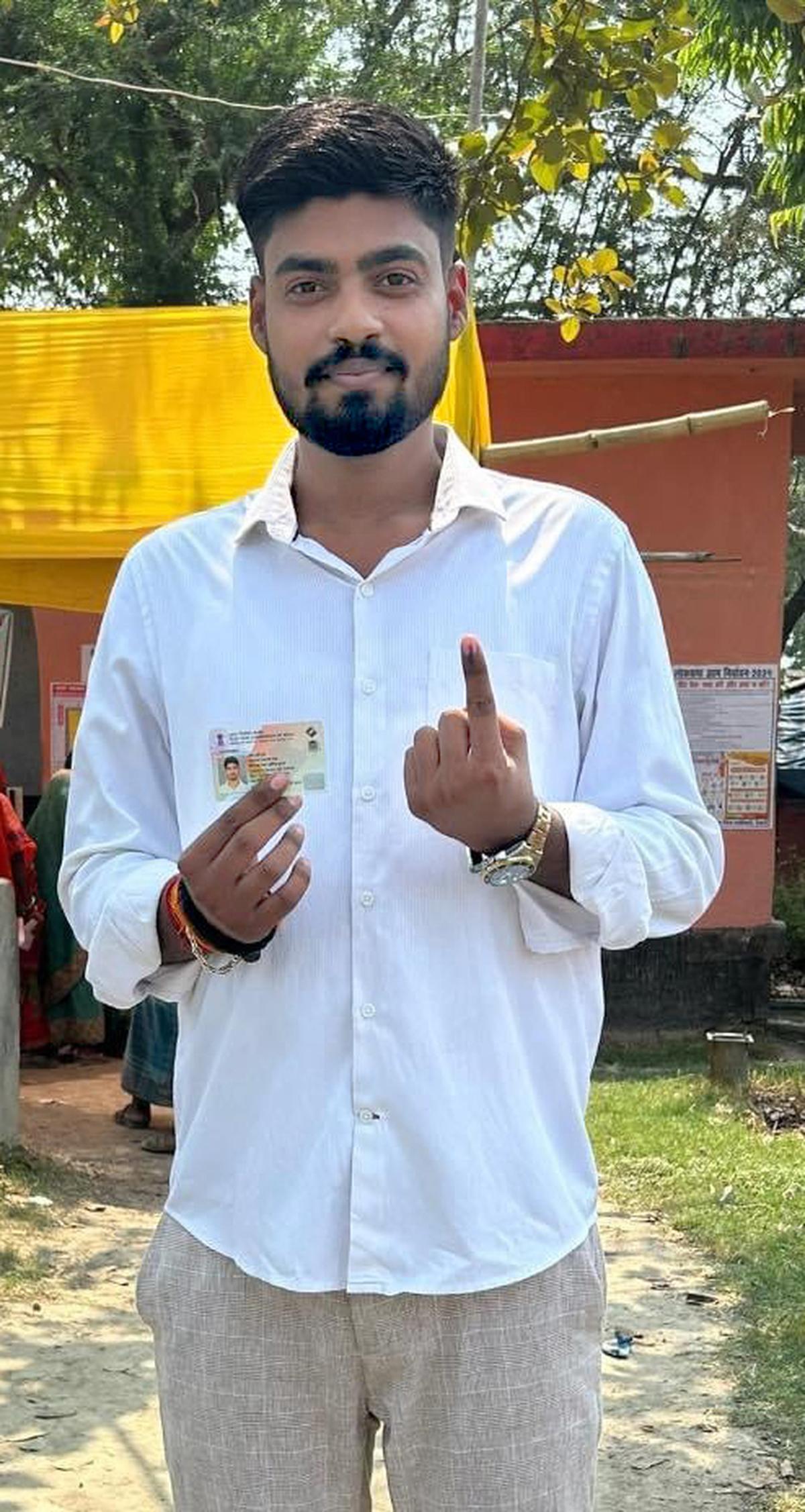 Raj shows his inked finger and voter ID after sporting the franchise for the first time.