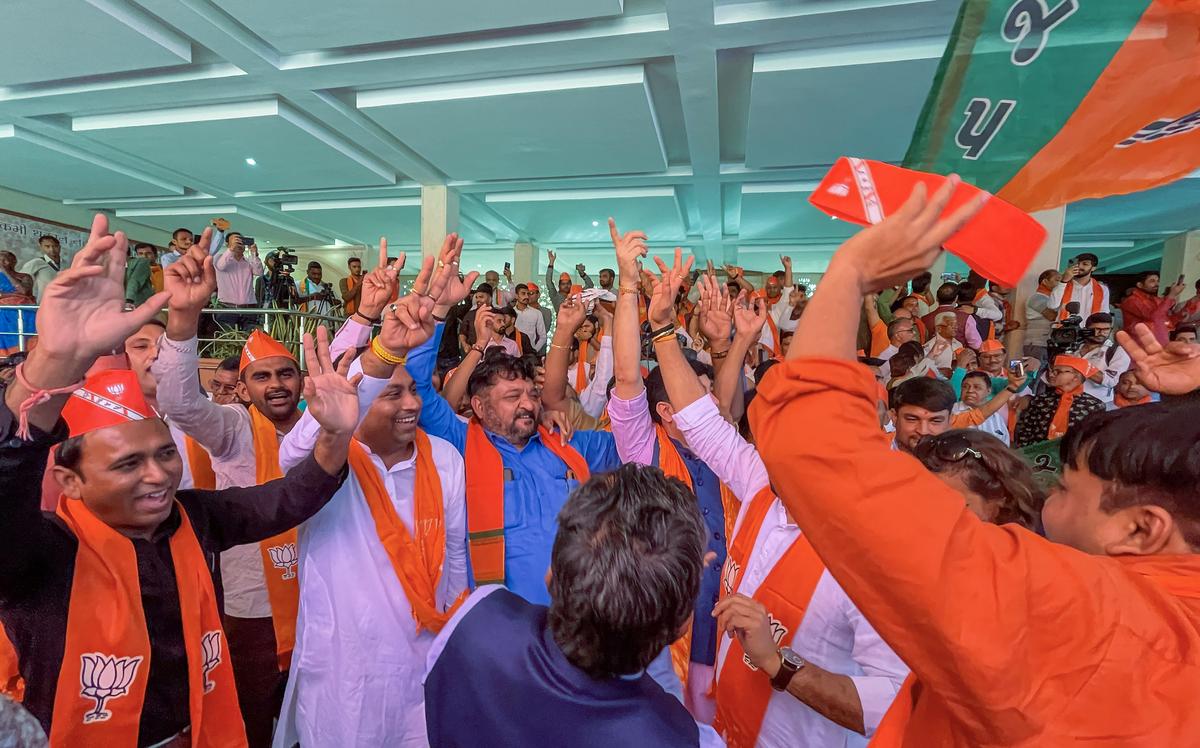 BJP leaders and workers dance as they celebrate the party’s decisive lead in Gujarat Assembly elections in Gandhinagar.
