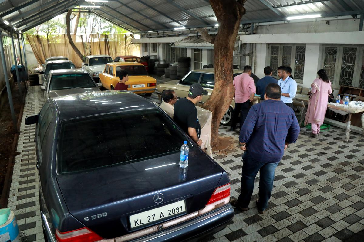 Customs officials inspect luxury cars at a garage in Kochi. 