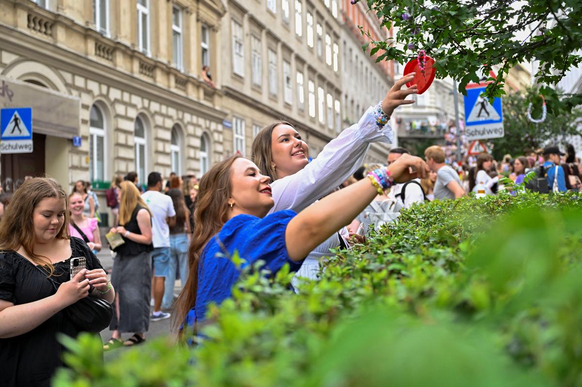 Fans of Taylor Swift leave bracelets on a tree and collect others as they gather following the cancellation of three Taylor Swift concerts at Happel stadium after the government confirmed a planned attack at the venue, in Vienna, Austria August 8, 2024