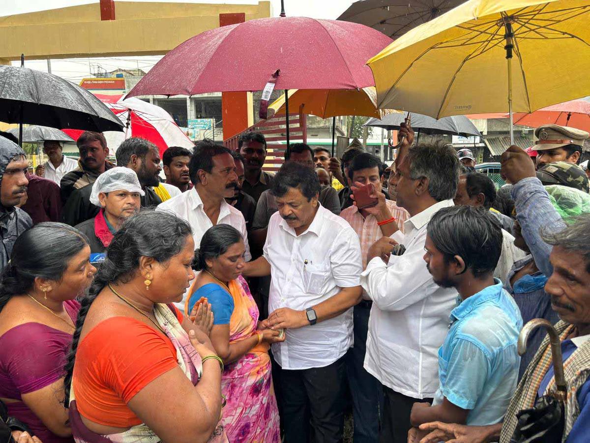 Tourism and Culture Minister Kandula Durgesh with the  family members of the deceased fisherman, in East Godavari district on Friday. 