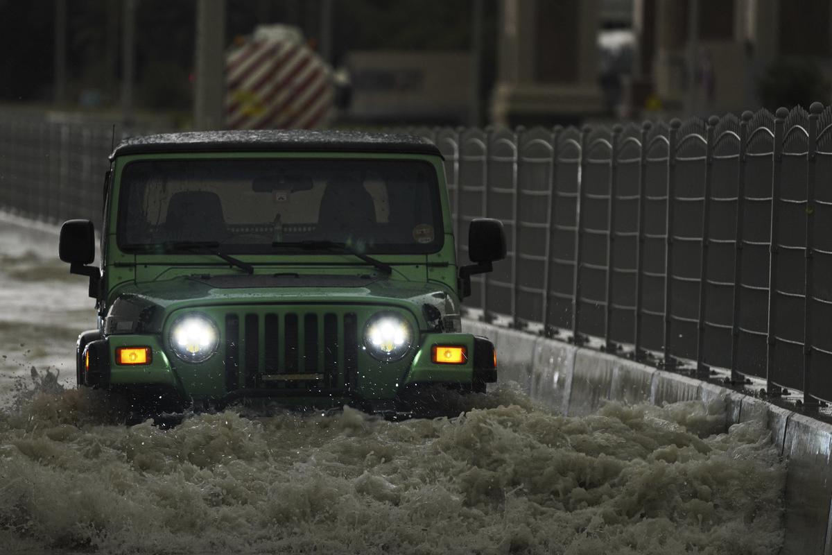 An SUV passes through standing water in Dubai, United Arab Emirates, Tuesday, April 16, 2024. 