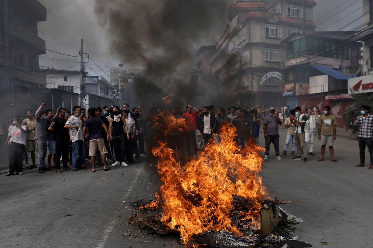 Demonstrators shout slogans as they gather to protest against Monday’s killing of 19 people after anti-corruption protests that were triggered by a social media ban which was later lifted, during a curfew in Kathmandu, on September 9, 2025