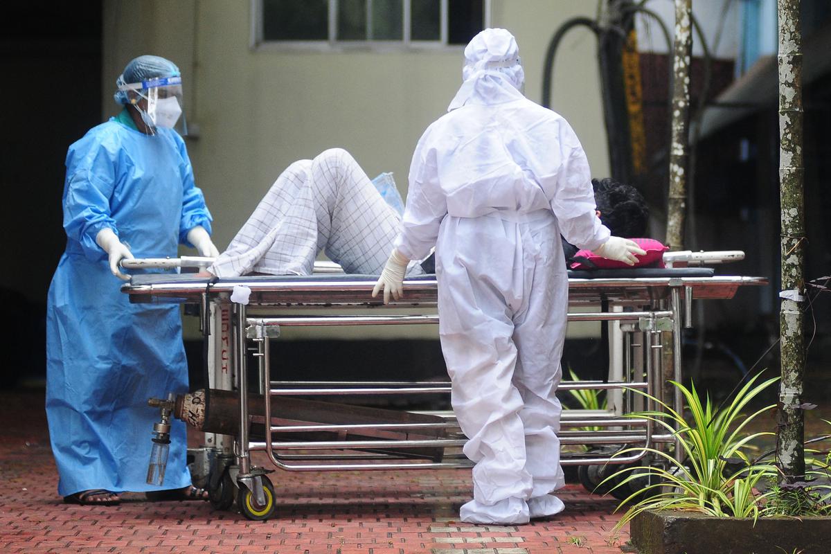 Health workers wearing protective gears shift a man with symptoms of Nipah virus to an isolation ward at a government hospital in Kozhikode in south Indian state of Kerala on September 16, 2023. (Photo by AFP)