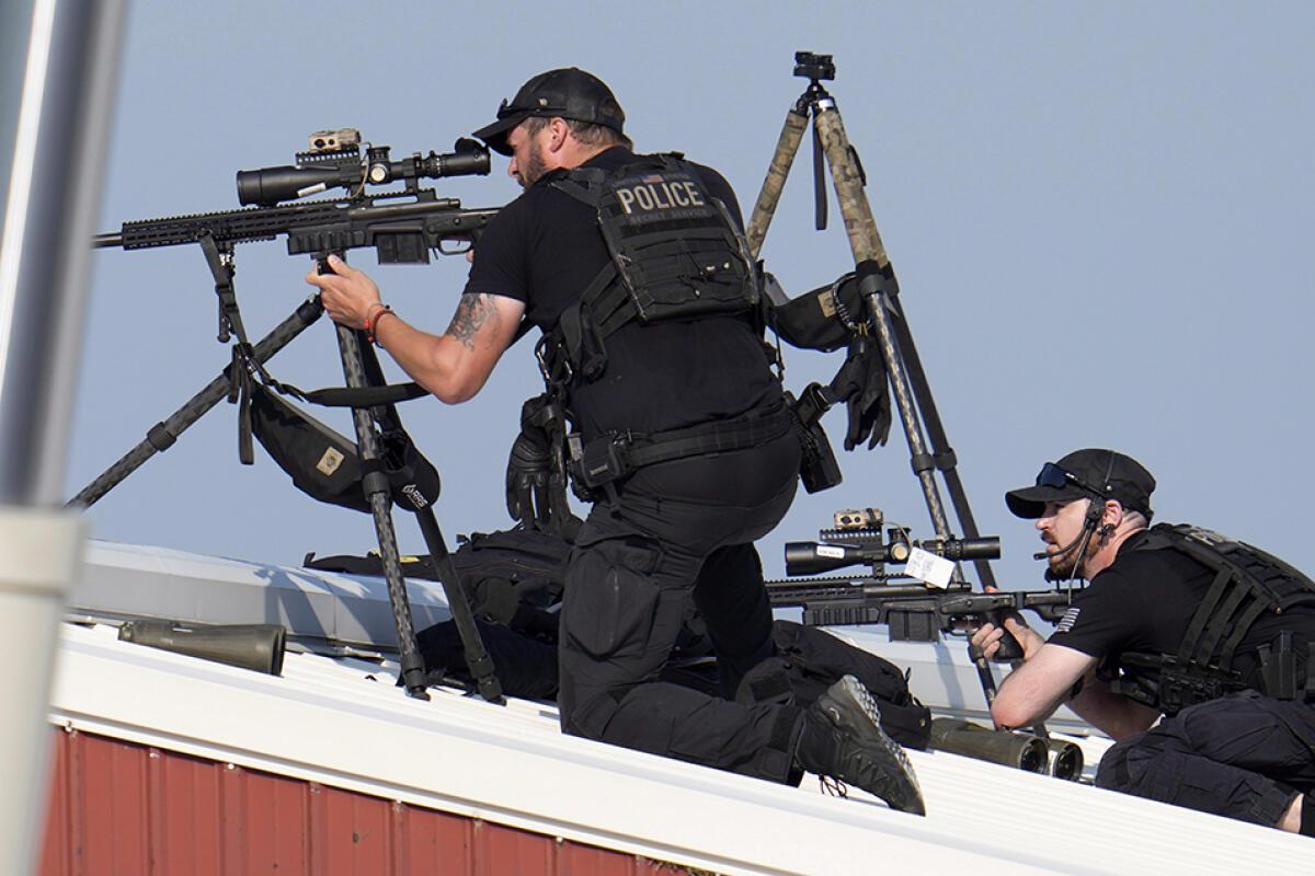 Police snipers return fire after shots were fired while Republican presidential candidate former President Donald Trump was speaking at a campaign event in Butler, Pa., on Saturday, July 13, 2024.