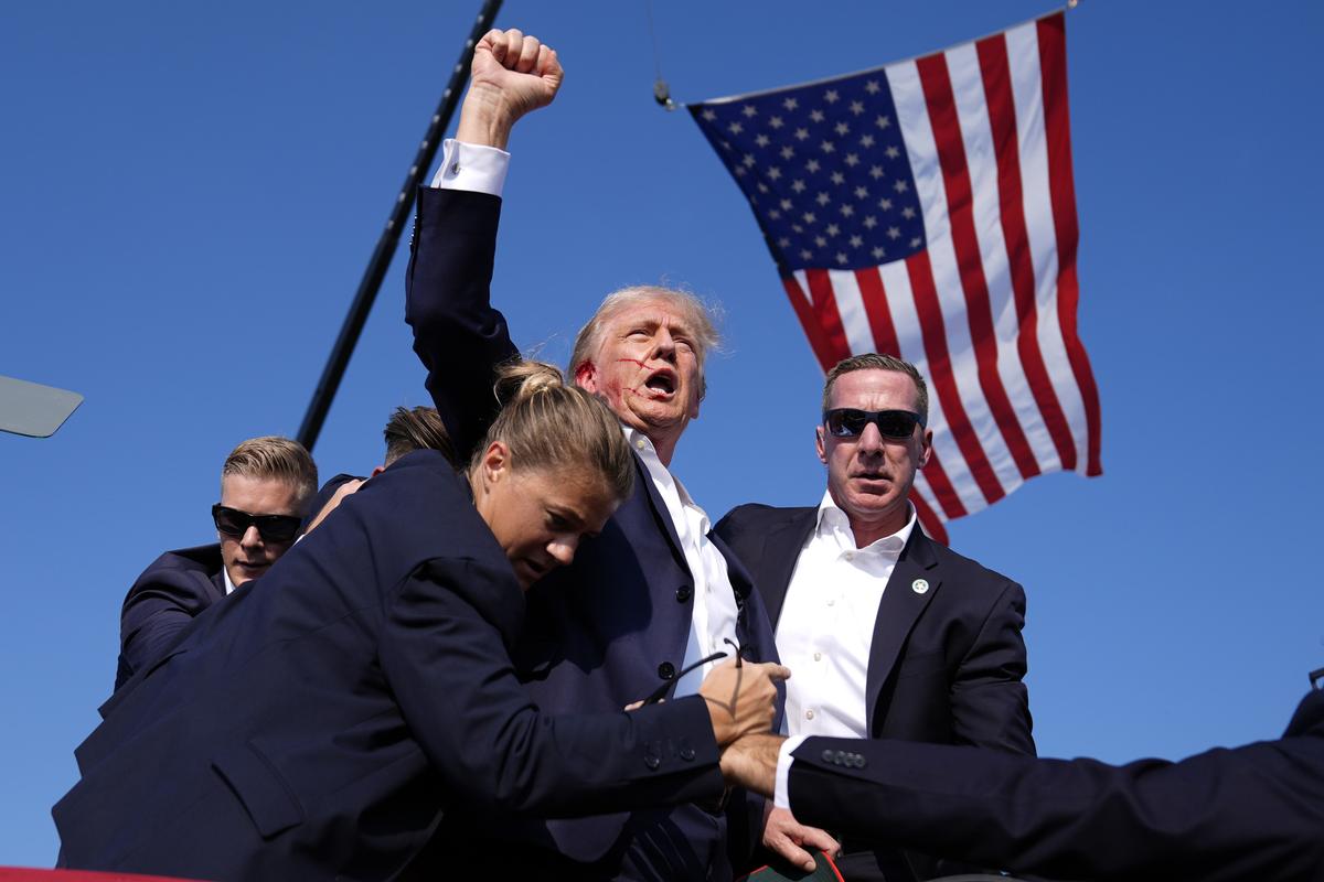 Donald Trump is surrounded by U.S. Secret Service agents at a campaign rally