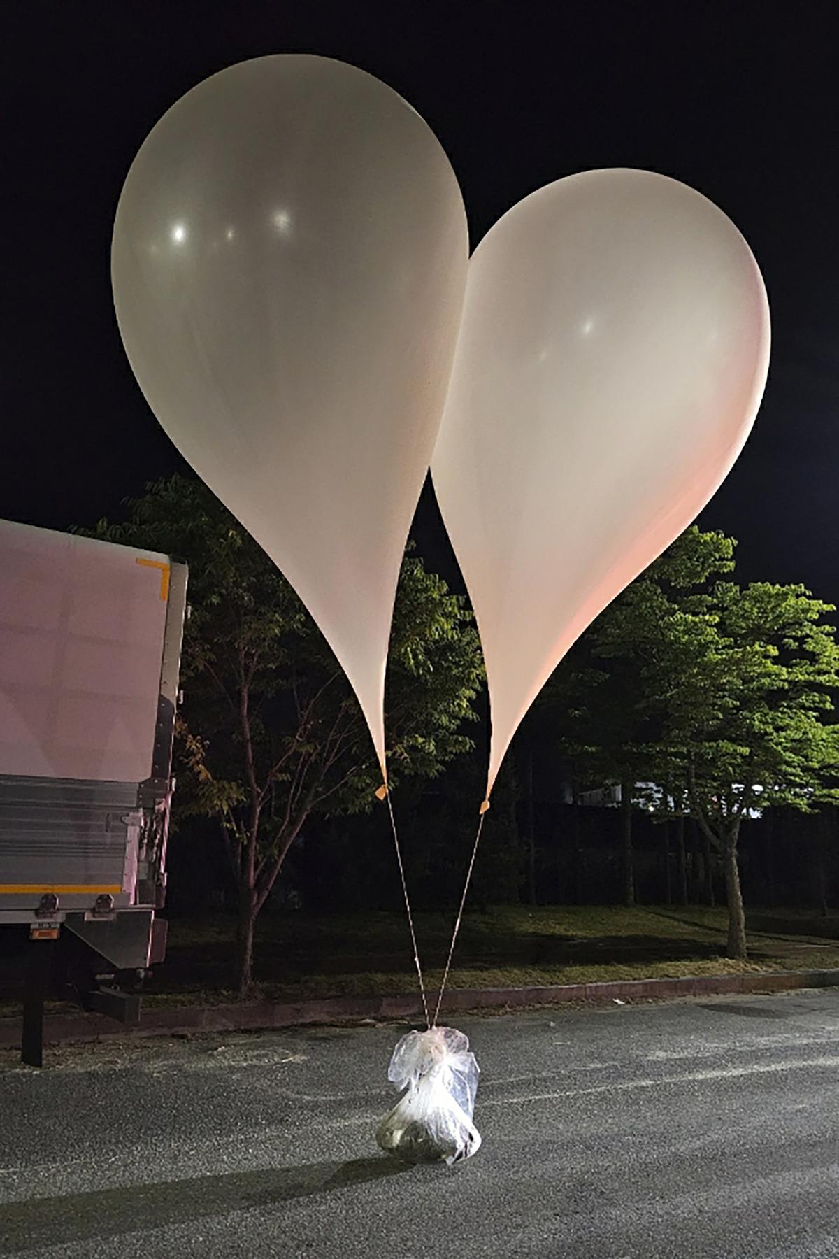 FILE - This photo provided by South Korea Defense Ministry, shows balloons with trash presumably sent by North Korea, in South Chungcheong Province, South Korea, on May 29, 2024. South Korea has recently retaliated for North Korea's trash-carrying balloon launches with propaganda loudspeaker broadcasts at border areas. The South Korean broadcasts reportedly included K-pop sensation BTS’s mega hits like “Butter” and “Dynamite,” weather forecasts and news on Samsung as well as outside criticism on the North’s missile program.(South Korea Defense Ministry via AP, File)