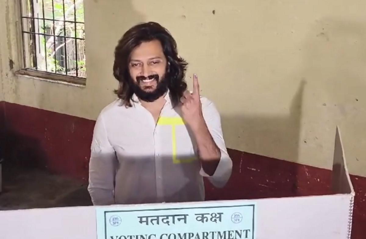 Actor Riteish Deshmukh shows his finger marked with indelible ink after casting vote during the Maharashtra Assembly elections, in Latur district