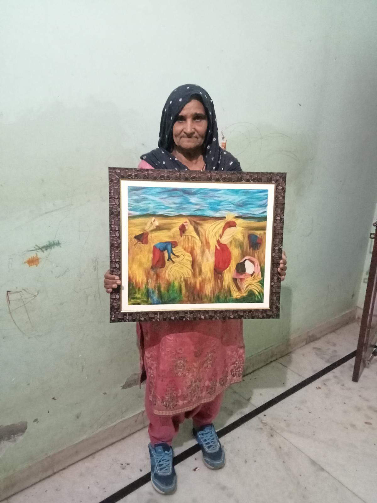 Virmati with Aban Raza’s painting of her village, Pengawan.