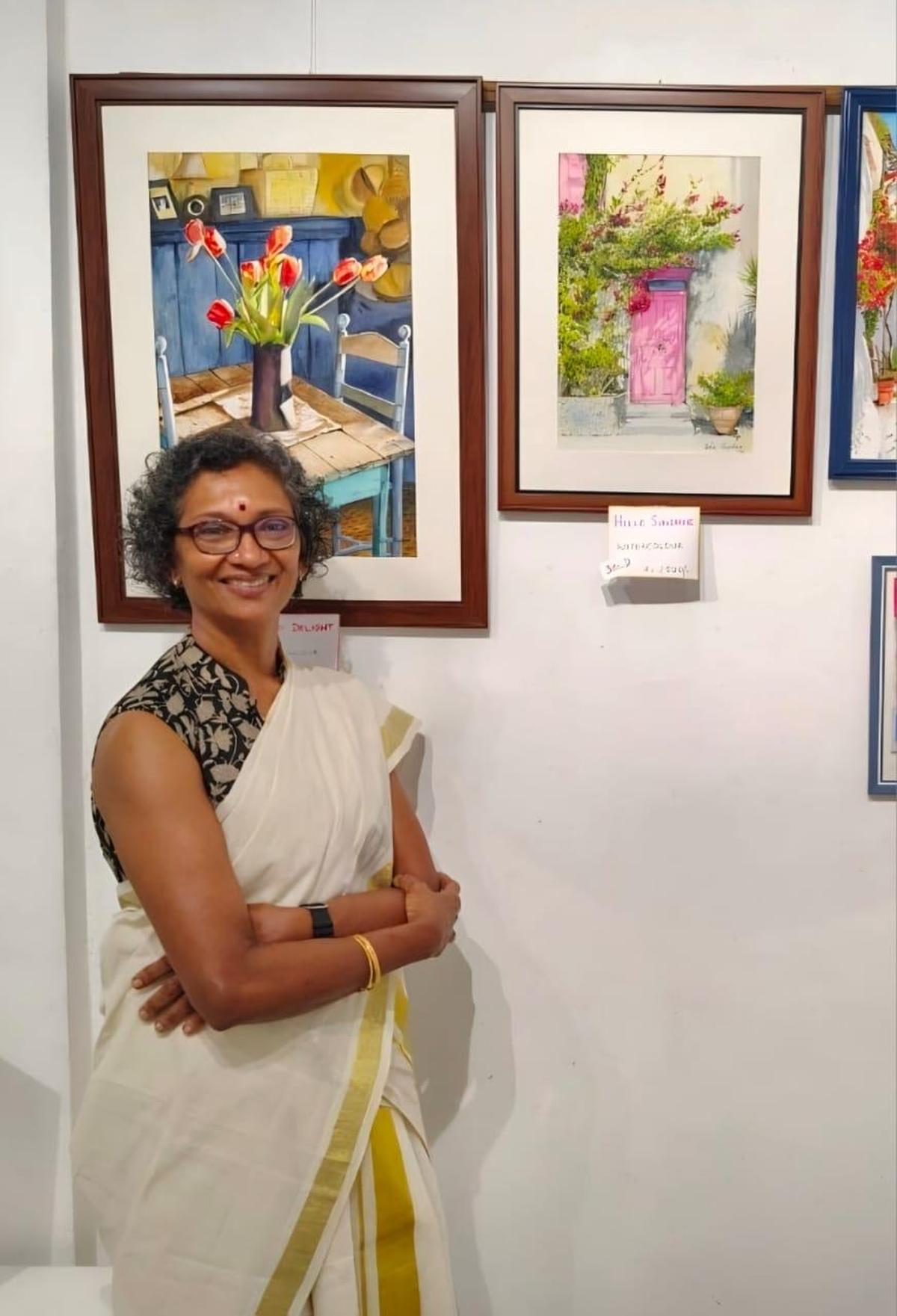 Dr Usha Shajehan with her paintings exhibited in Thiruvananthapuram Dr Usha Shajehan with her paintings exhibited in Thiruvananthapuram