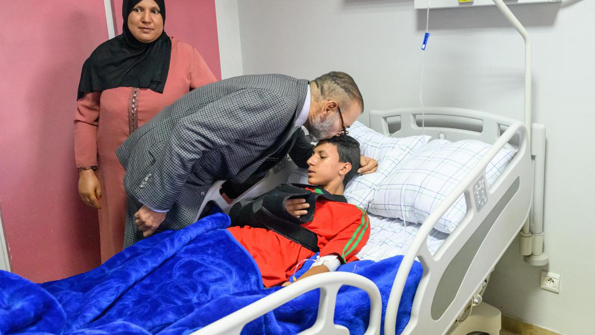 King of Morocco visits earthquake patients at Marrakech, kissing one on head and donating blood