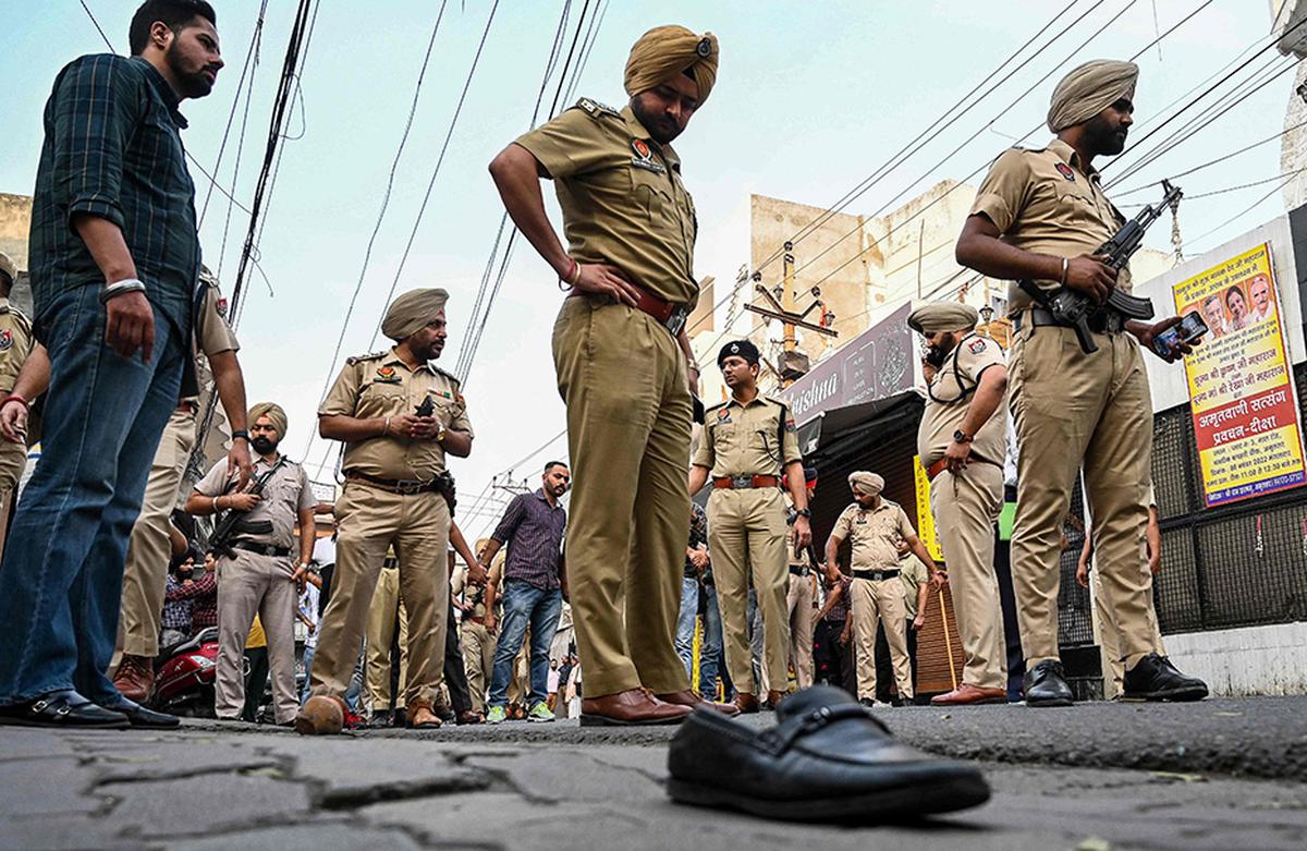 Police inspect the site where Shiv Sena leader Sudhir Suri was shot dead. 