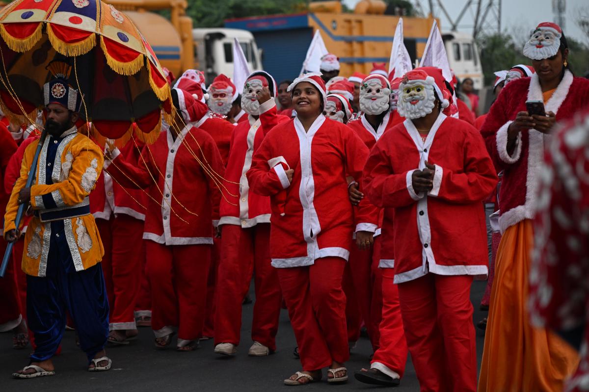 People dressed as Santa Claus gather during an event held ahead of Christmas celebrations at Mint in Chennai on Sunday. 