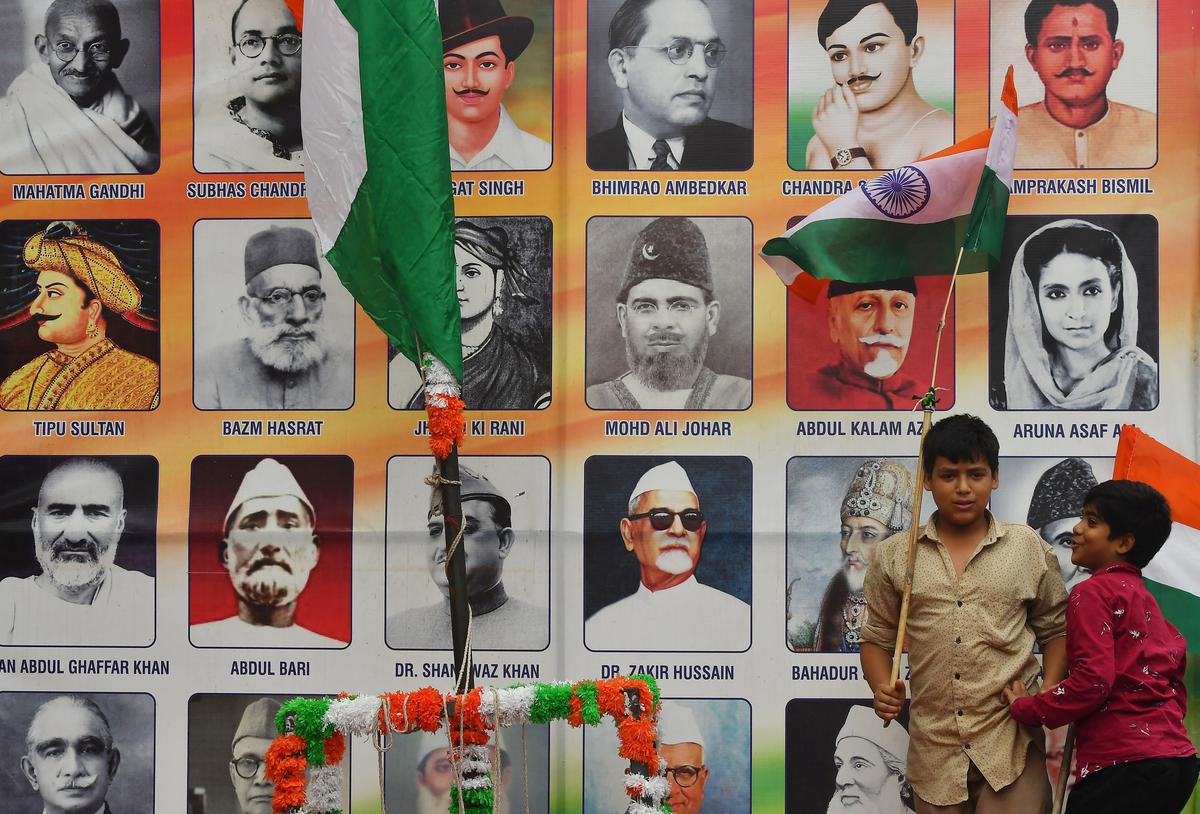 A young boy waves the national flag against the backdrop of a collage of national leaders in Hyderabad on Monday.