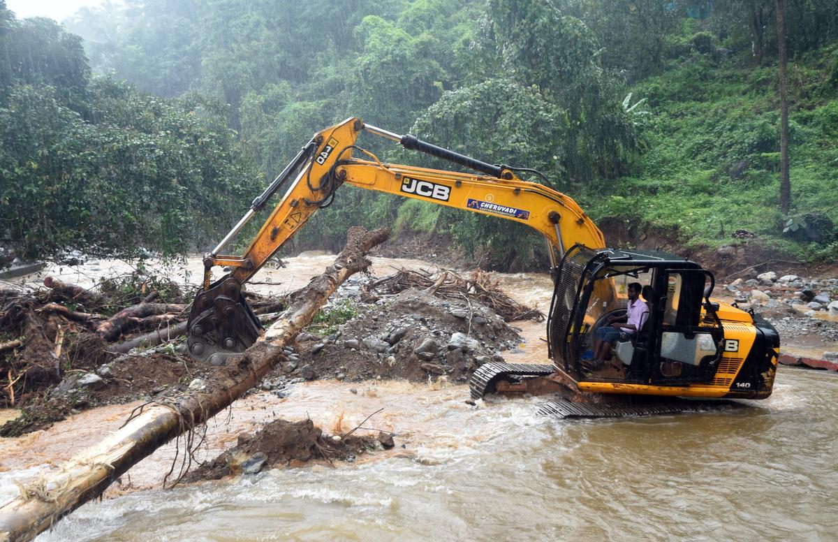 An earth mover being used to clear the debris from the site of the landslip-hit Small Hydro Electric Project at Vilangad in Kozhikode on Sunday. 