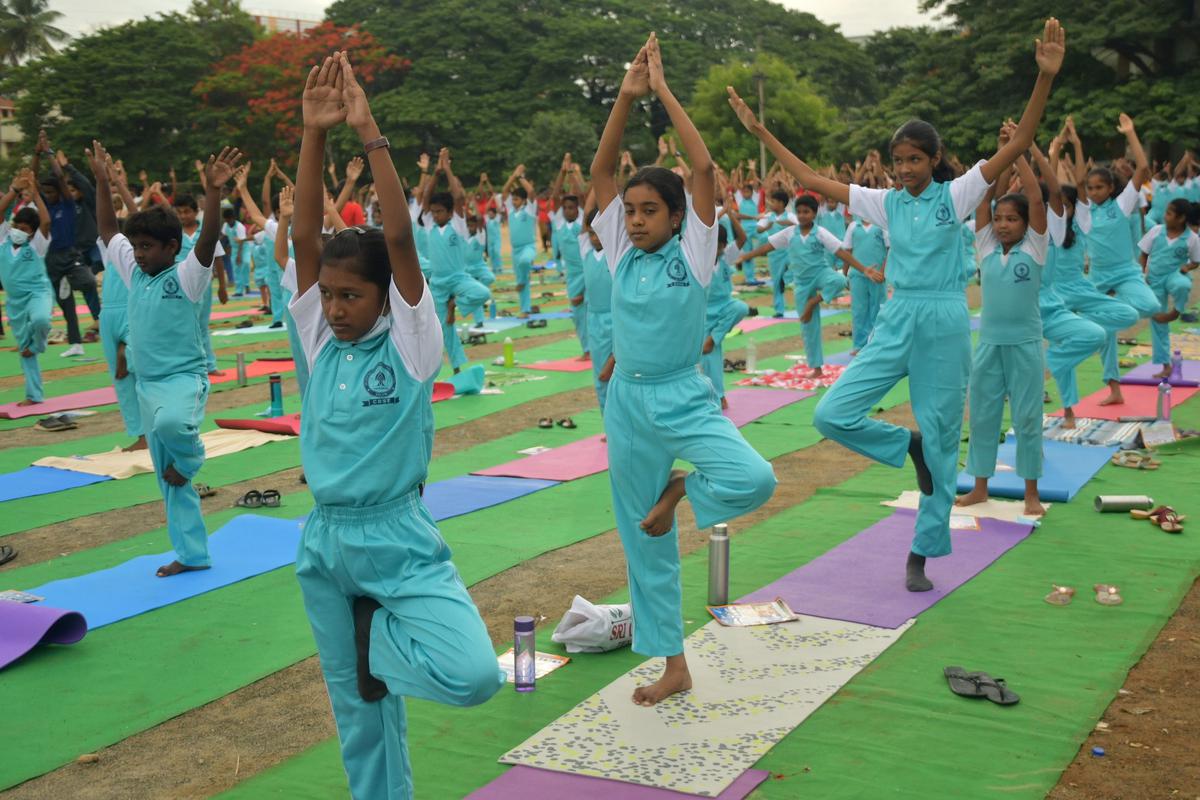 Children practising asanas during the International Day of Yoga celebrations organised by Nehru Yuva Kendra at Mahatma Gandhi Stadium in Salem in Tamil Nadu on Tuesday, June 21, 2022. 