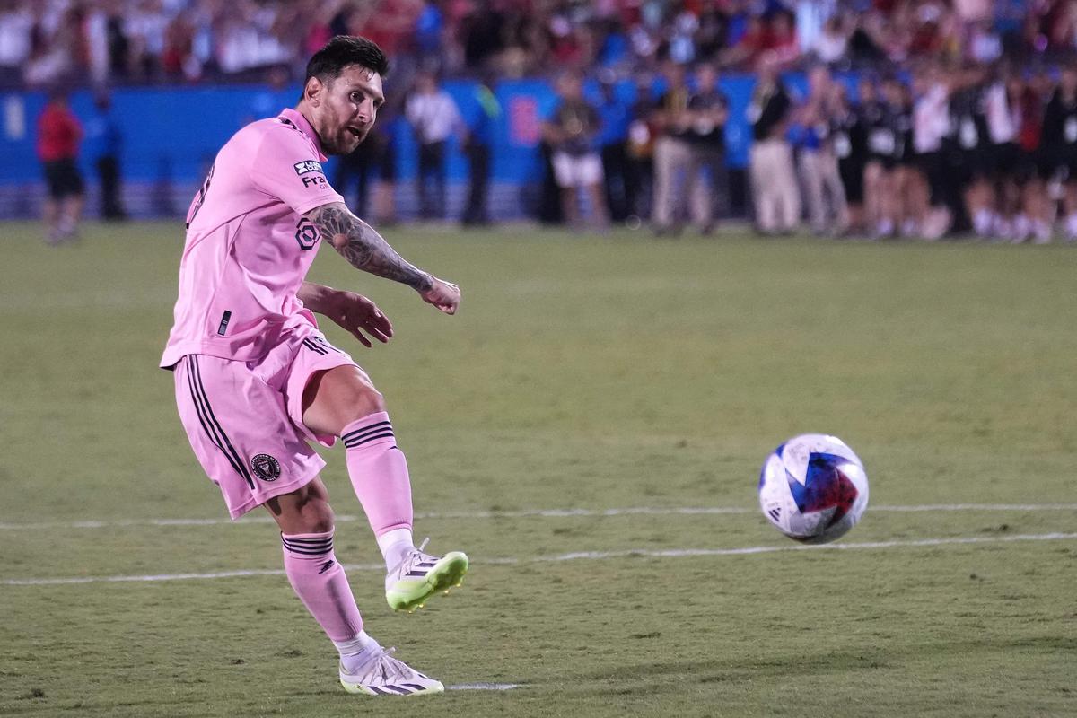 messi kicking a soccer ball