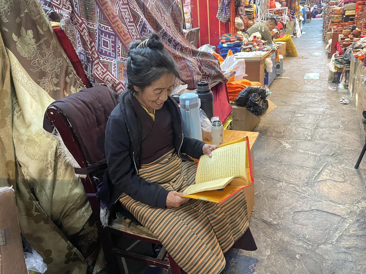 A Tibetan shopkeeper outside her stall in Lhasa.