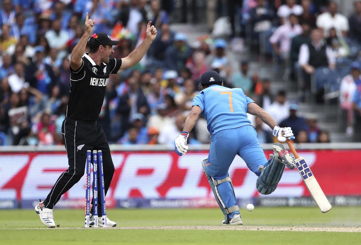 New Zealand’s Colin de Grandhomme, left, celebrates the run-out of India’s MS Dhoni, right, during the Cricket World Cup semi-final match between India and New Zealand at Old Trafford in Manchester, England, on July 10, 2019. 