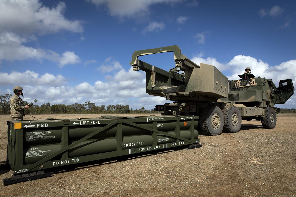 U.S. Army prepares the crane for loading the Army Tactical Missile System (ATACMS) on to the High Mobility Artillery Rocket System (HIMARS)