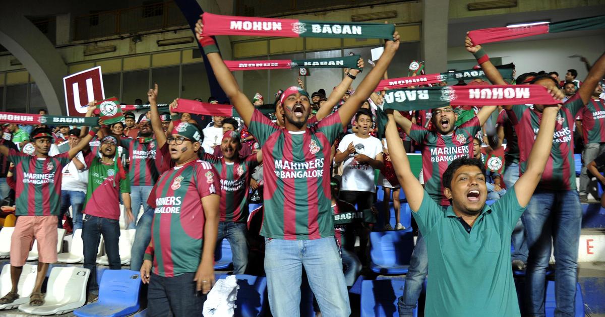 Supporters of Mohun Bagan from West Bengal celebrate their team's first goal in the I-League football match against Bengaluru FC at Sree Kanteerava Stadium in Bengaluru on February 13, 2016.